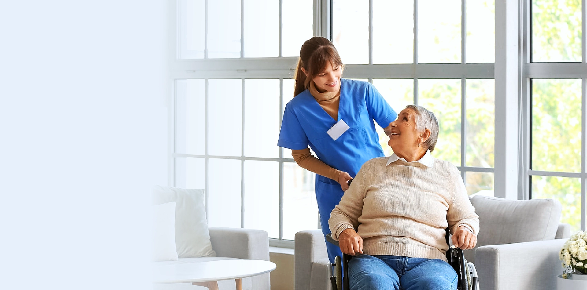 A female caregiver and a senior woman sitting on a wheelchair