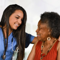 caretaker taking care of an elderly woman