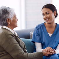 young nurse chatting to a elderly woman in a retirement home