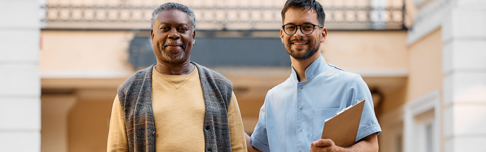 A senior man and male smiling together