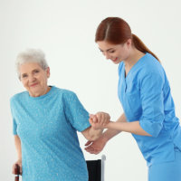 Person helping an elderly woman