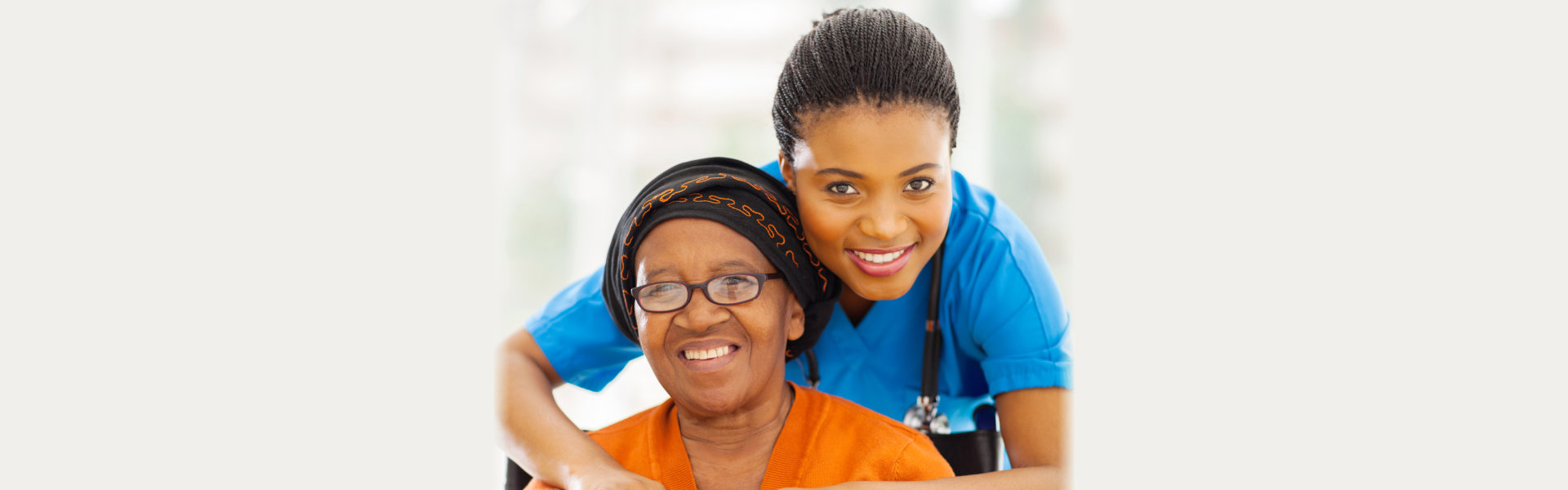 Caregiver with an elderly woman smiling