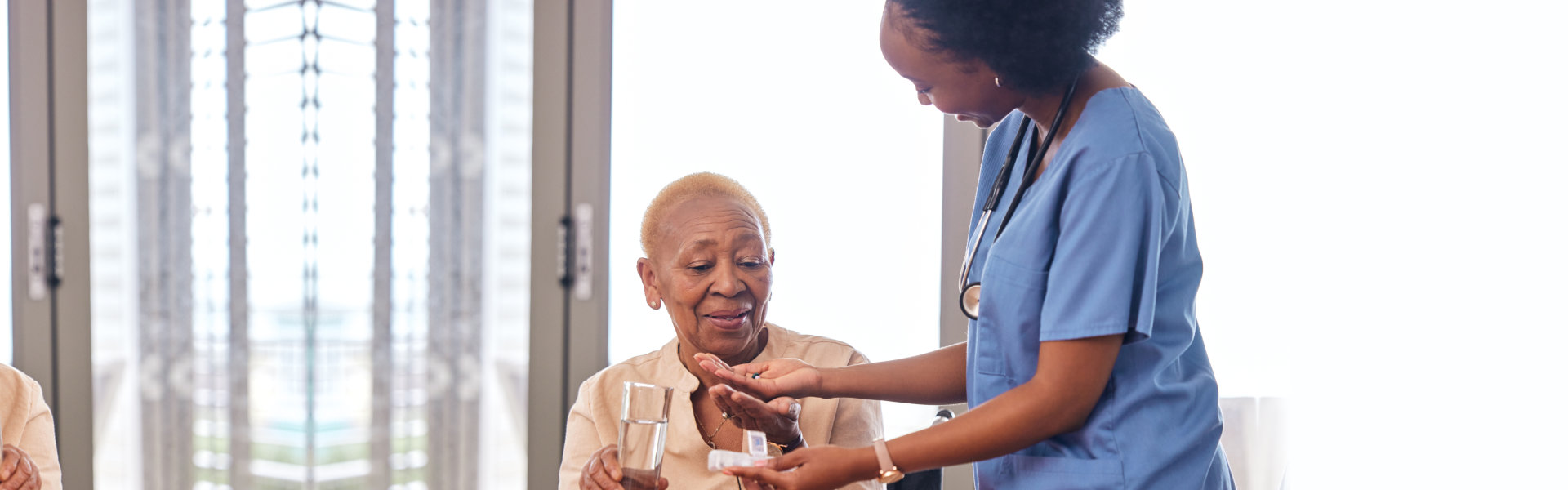 caretaker taking care of an elderly woman