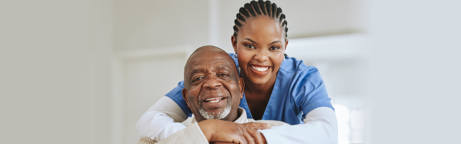 Elderly man and the caregiver smilling