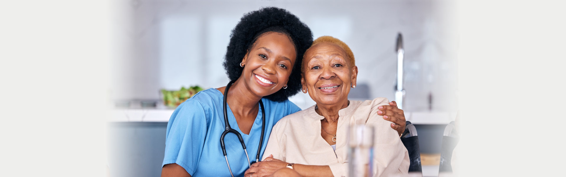 caretaker and an elderly woman smilling